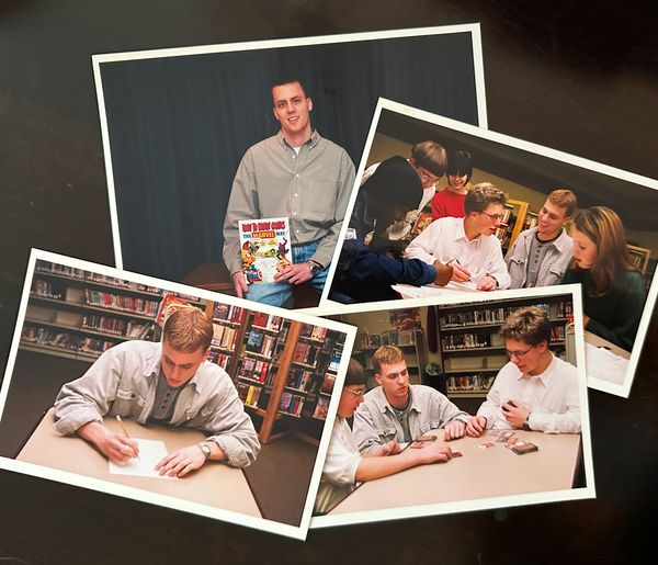 Four printed photos: a young Jamie Gerrard holding a How to Draw Comics the Marvel Way book and sketching among bookshelves, and teens drawing and playing cards at library tables.