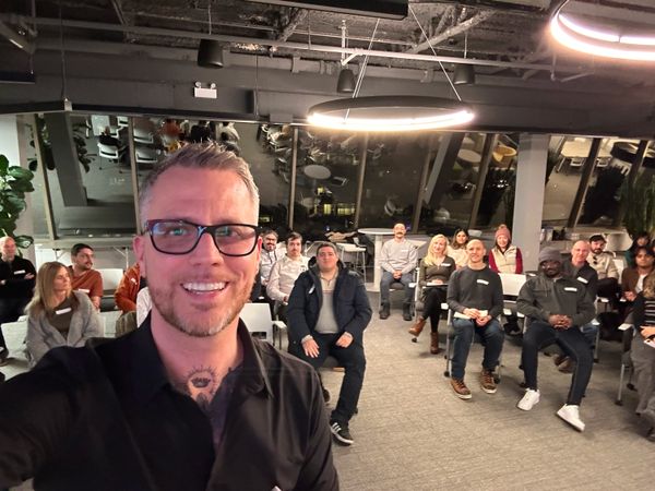 Jamie Gerrard taking a selfie in front of a seated audience at Volta in Halifax.