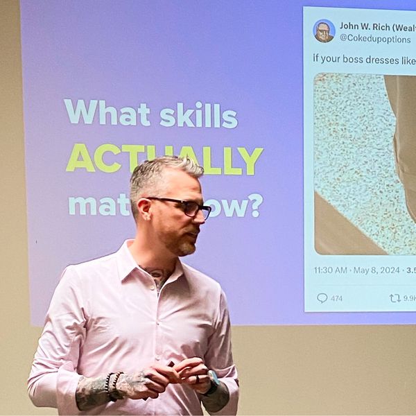 Jamie Gerrard presenting in front of a slide that asks, What skills actually matter now?